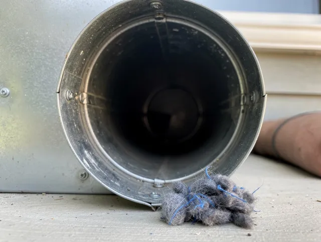 Avon Dryer Vent Cleaning technician using specialized equipment to clear severe dryer vent blockage in Avon